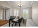 Cozy dining area featuring plantation shutters, wainscoting, and a chandelier at 1175 Johnston Path, The Villages, FL 32162