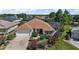 Charming home with an attached garage, lanai and beautiful landscaping and a brick driveway at 1175 Johnston Path, The Villages, FL 32162