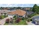 Aerial view of a charming single Gathering home with a lush lawn, beautiful landscaping, and a screened-in pool at 1175 Johnston Path, The Villages, FL 32162