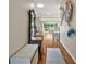 Bright hallway with hardwood floors, decorative art and plenty of natural light with views of living area at 1175 Johnston Path, The Villages, FL 32162