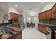 Spacious kitchen featuring stainless steel appliances, granite countertops, breakfast nook, and tile flooring at 1175 Johnston Path, The Villages, FL 32162