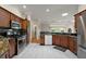 Open kitchen with granite countertops, stainless steel appliances, and tile flooring overlooking backyard at 1175 Johnston Path, The Villages, FL 32162