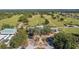 An aerial view of the golf course clubhouse, with lush greenery and a well-manicured landscape at 11868 Se 91St Cir, Summerfield, FL 34491