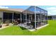 Charming backyard with a screened patio, perfect for entertaining or relaxing outdoors at 11868 Se 91St Cir, Summerfield, FL 34491