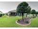 Expansive backyard with a screened patio, mature trees, and meticulously maintained landscaping at 11868 Se 91St Cir, Summerfield, FL 34491