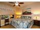 Inviting bedroom with a ceiling fan, a large bed, and decorative bedside tables at 11868 Se 91St Cir, Summerfield, FL 34491