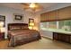 Comfortable bedroom with ceiling fan, large window, and neutral decor at 11868 Se 91St Cir, Summerfield, FL 34491
