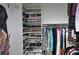 Walk-in closet with custom shoe shelving and organized hanging space at 11868 Se 91St Cir, Summerfield, FL 34491
