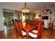 Elegant dining room featuring a wooden table and decorative chandelier, with view of living room at 11868 Se 91St Cir, Summerfield, FL 34491