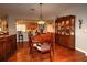 Elegant dining room with wooden floors, large hutch, and unique chandelier, perfect for entertaining guests at 11868 Se 91St Cir, Summerfield, FL 34491