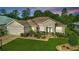 Charming single-story home boasts lush landscaping, inviting front porch, and well-manicured lawn at 11868 Se 91St Cir, Summerfield, FL 34491