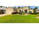 Beautiful single-story home featuring a well-manicured lawn, a two-car garage, and a charming front entrance at 11868 Se 91St Cir, Summerfield, FL 34491