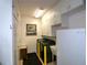 Well-lit laundry room featuring a modern washer and dryer, ample storage cabinets, and a convenient utility sink at 11868 Se 91St Cir, Summerfield, FL 34491
