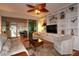 Bright living room with a sliding glass door that leads to an outdoor seating area and pool at 11868 Se 91St Cir, Summerfield, FL 34491