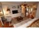 Cozy living room with built-in shelving, a ceiling fan, and plush seating at 11868 Se 91St Cir, Summerfield, FL 34491