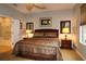 Well-lit main bedroom featuring a ceiling fan and a comfortable bed with nightstands, creating a relaxing space at 11868 Se 91St Cir, Summerfield, FL 34491