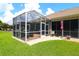 Inviting screened patio area perfect for relaxation and entertainment, with lush green surroundings at 11868 Se 91St Cir, Summerfield, FL 34491