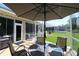 Enjoy outdoor living in this screened-in patio with a dining set and views of the lush backyard at 11868 Se 91St Cir, Summerfield, FL 34491