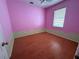 Bedroom with light wood floors, a single window, and a unique two-tone wall design in pink and green at 1209 Cathcart Cir, Sanford, FL 32771