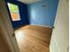 Bedroom with laminate flooring and bright blue walls; a window provides natural light at 1209 Cathcart Cir, Sanford, FL 32771
