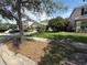 Inviting home with a two-car garage, mature tree in the front yard, and neatly manicured landscaping at 1209 Cathcart Cir, Sanford, FL 32771