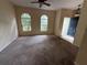 Spacious living room with carpet and natural light from arched windows in neutral tones at 1209 Cathcart Cir, Sanford, FL 32771
