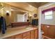 Bathroom vanity with a mirror, wood cabinets, and a separate toilet area at 124A Shady Ln, Eustis, FL 32726
