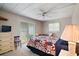 Cozy bedroom with a quilt-covered bed, a dresser, and sliding glass doors to the outside at 124A Shady Ln, Eustis, FL 32726