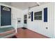 Cozy entrance with a blue door, white railings and a clock on the wall at 124A Shady Ln, Eustis, FL 32726