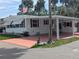 Charming home with a covered carport, tidy landscaping, and a welcoming entrance at 124A Shady Ln, Eustis, FL 32726