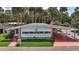 Charming single-story home with vibrant lawn and a covered carport for convenient parking at 124A Shady Ln, Eustis, FL 32726