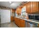Charming kitchen featuring wood cabinets, stainless steel appliances, and access to the dining area at 124A Shady Ln, Eustis, FL 32726