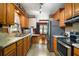 Traditional kitchen with light-wood cabinets, tile flooring, and stainless-steel appliances at 124A Shady Ln, Eustis, FL 32726