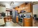 Open kitchen featuring wood cabinets, stainless steel appliances, and access to the dining area at 124A Shady Ln, Eustis, FL 32726