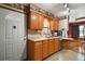 Bright kitchen featuring wood cabinets, tile floors, and stainless steel dishwasher and microwave at 124A Shady Ln, Eustis, FL 32726
