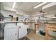 Functional laundry area with washer, dryer, storage shelves and utility sink at 124A Shady Ln, Eustis, FL 32726