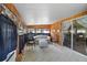 A well lit sunroom with wood paneled walls and plush carpeting at 124A Shady Ln, Eustis, FL 32726