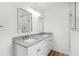 Bathroom featuring dual sinks with granite counters and a glass-enclosed shower at 1313 Arredondo Dr, The Villages, FL 32162