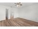 Spacious and bright bedroom with laminate flooring, ceiling fan, and a door to the en suite bathroom at 1313 Arredondo Dr, The Villages, FL 32162