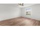 Bright bedroom featuring wood floors, a ceiling fan, and a window with a view at 1313 Arredondo Dr, The Villages, FL 32162