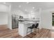 Bright kitchen featuring an island with seating, stainless steel appliances and an adjacent dining area at 1313 Arredondo Dr, The Villages, FL 32162