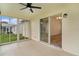 Enclosed lanai with ceiling fan offers seamless transition to indoor living space with bright, natural light and neutral finishes at 1313 Arredondo Dr, The Villages, FL 32162