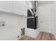 Functional laundry room features laminate flooring, white cabinetry, a utility sink and plenty of storage space at 1313 Arredondo Dr, The Villages, FL 32162