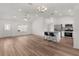 Bright living room featuring hardwood floors, neutral walls, a ceiling fan and an open concept layout at 1313 Arredondo Dr, The Villages, FL 32162