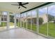 Bright sun room with walls of windows, tiled floor, and view of backyard at 1313 Arredondo Dr, The Villages, FL 32162