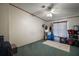 Neutral bedroom featuring green carpet, ceiling fan, and window with natural light at 13137 Kansas Ave, Astatula, FL 34705