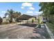 Property featuring a long driveway, carport, and tidy landscaping at 13137 Kansas Ave, Astatula, FL 34705