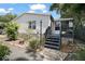 Charming single-story home featuring tidy landscaping, welcoming front porch and light gray siding at 13137 Kansas Ave, Astatula, FL 34705