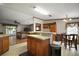 Open kitchen area with light countertops, wood cabinets, and an adjacent living space at 13137 Kansas Ave, Astatula, FL 34705