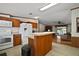 Bright kitchen with white appliances, wood cabinets, and a peninsula open to the living room at 13137 Kansas Ave, Astatula, FL 34705